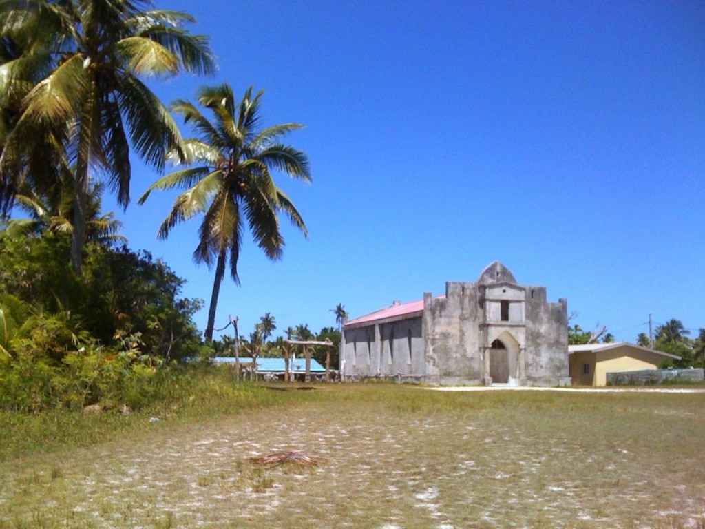 church next to coconut trees plantation